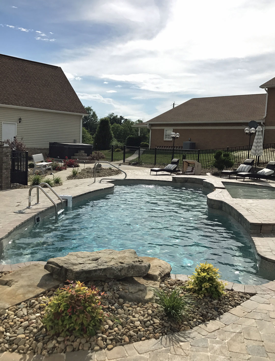 Extensive Hardscaping Surrounds A Multi-Level Swimming Pool in Hamblen County Tennessee