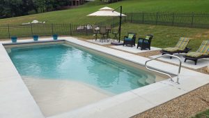 Fiberglass Pool With a Variety of Options for Lounging Poolside