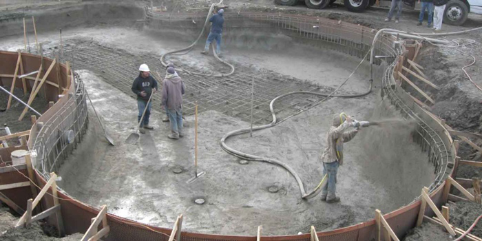 Construction of gunite concrete pool at the phase of spraying concrete
