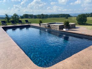 Beautiful swimming pool with waterfall with Greene Mountain and the Blue Ridge Mountains across the horizon