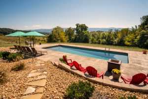 A swimming pool with lounge chairs overlooking the Blue Ridge Mountains in Parrottsville, TN