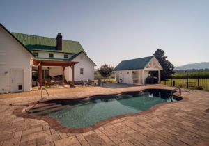 Expansive and interesting paver decking surrounds this fiberglass pool with Tennessee mountains in the background