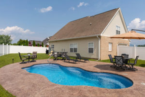 A fiberglass lagoon pool installed in a small backyard in a subdivision in Jonesborough, Tennessee