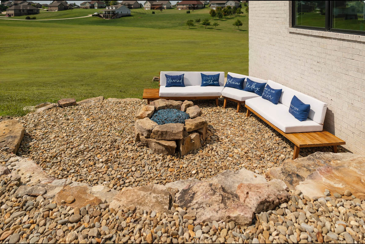 Poolside firepit lounge area executed in natural stone