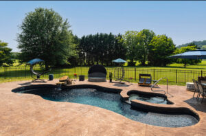 Lagoon pool with spa in farmland with lots of interesting chairs and loungers to relax by the pool