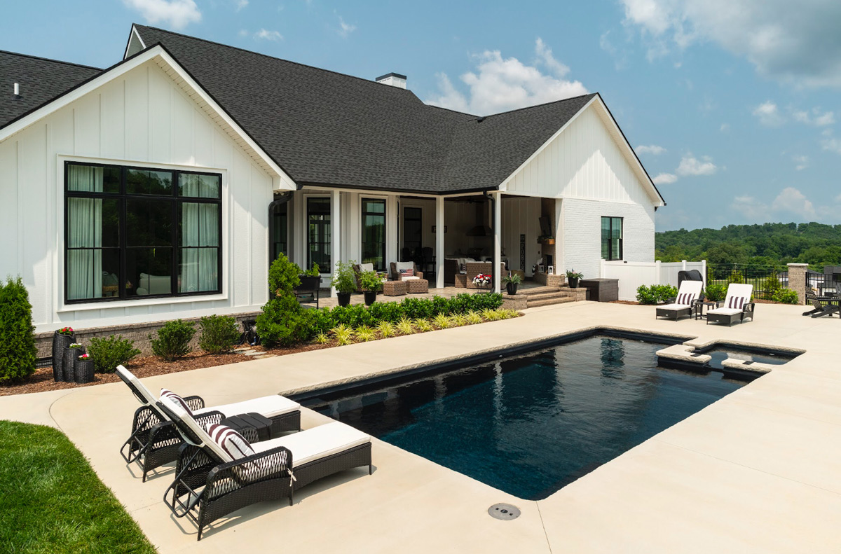 Modern farmhouse new construction with simple elegant pool and landscaping added to back courtyard