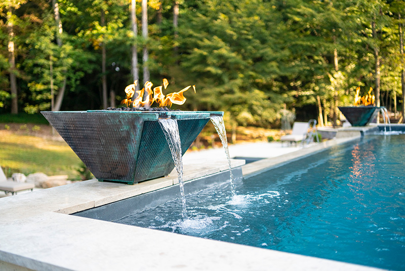 Detail of poolside fire bowl with scuppers