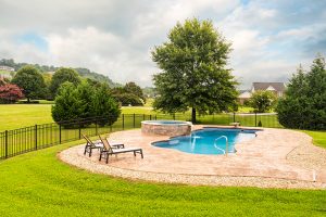 circular soaker spa with waterfall into small lagoon pool in the suburbs of Johnson City