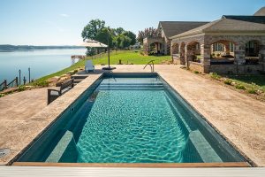 fiberglass lap pool near stone cabana alongside like